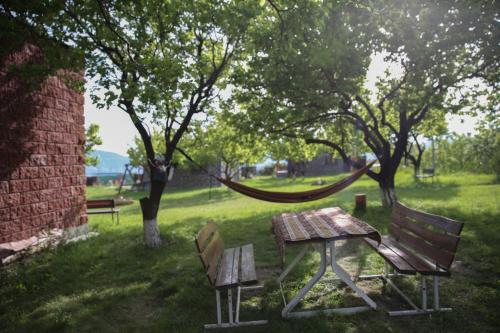 a picnic table and a hammock in a park at Noravank L-and-L in Aghavnadzor