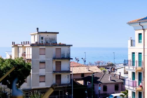 a city with buildings and the ocean in the background at Victoria Apartment in Bordighera