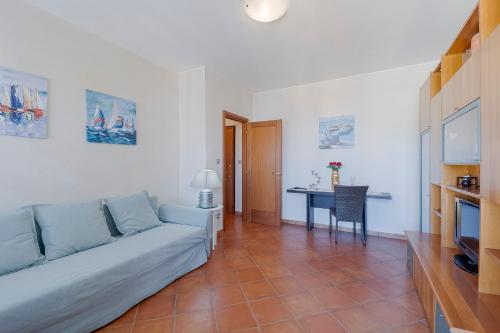 a living room with a couch and a table at Victoria Apartment in Bordighera