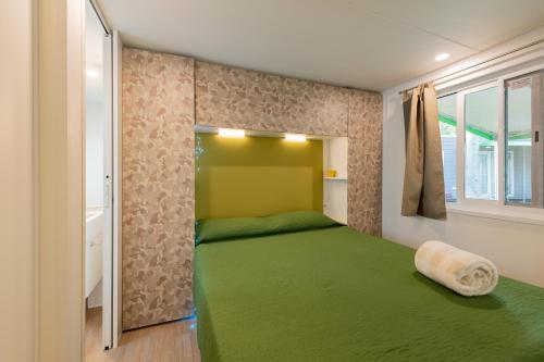 Een bed of bedden in een kamer bij San Francesco Camping Village