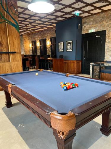 a pool table in a billiard room with at Studio One Hotel in Dubai