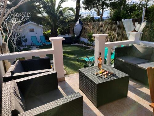 a patio with two couches and a table with drinks on it at D'art d'art à Sanary in Sanary-sur-Mer