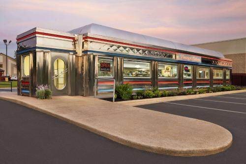 a rendering of a train car in a parking lot at Baymont by Wyndham Hearne in Hearne