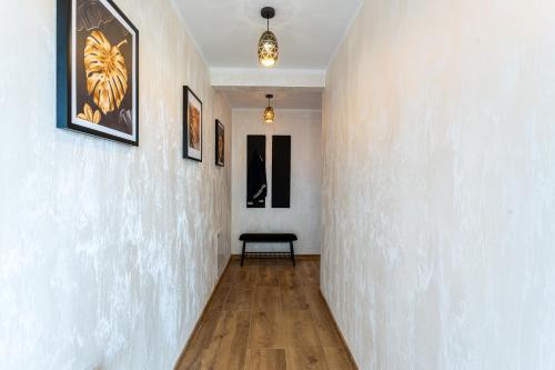 a hallway with a white wall with a bench in it at Villa Sol in Oświęcim