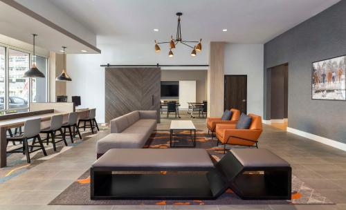 a living room with a couch and chairs and a table at Hyatt House Portland/Beaverton in Beaverton