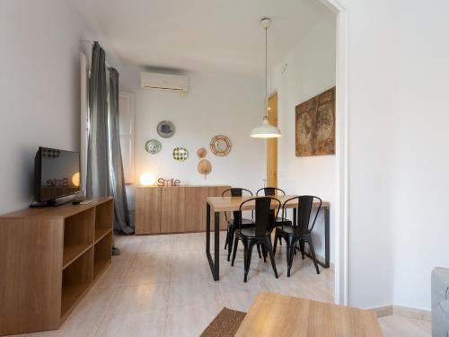 a dining room and living room with a table and chairs at Centric Sagrada Familia Apartments in Barcelona