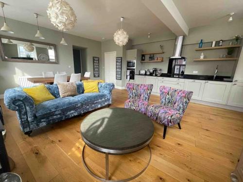 a living room with a couch and chairs and a table at Luxurious 2 bedroom apartment in central Berwick in Berwick-Upon-Tweed