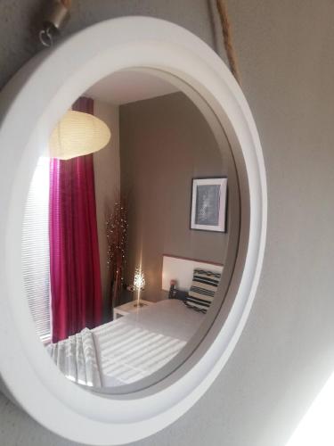 a reflection of a bedroom in a mirror at Apartments Villa Dona in Vela Luka