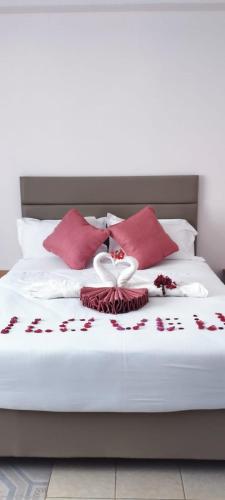 a bed with red and white flowers on it at Mataman Gardens in Naivasha