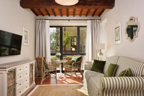 a living room with a couch and a table at Borgo Antico Casalbosco Holiday Home & Winery in Santomato 