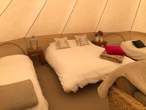 a bedroom with two beds in a tent at Old Oak Farm 