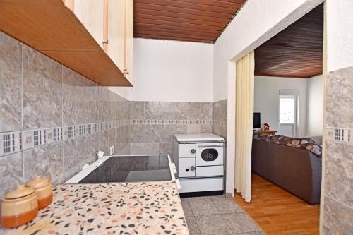 a kitchen with a sink and a stove at Country House Vukmanovic Bukovik in Virpazar