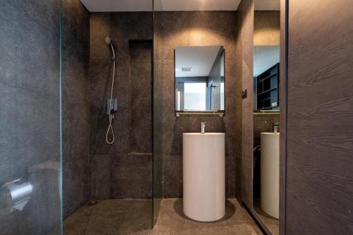 a bathroom with two sinks and a shower at Tropics Kamala Deluxe Pool View Apartment CTG P402 in Kamala Beach