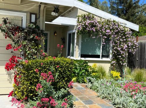 a flower garden in front of a house with flowers at Palo Alto Quiet 1 Bedroom Stanford University in Palo Alto