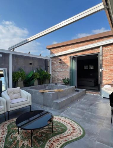 a patio with a couch and a table at Jeonju Hanok Village, Maison14 in Jeonju