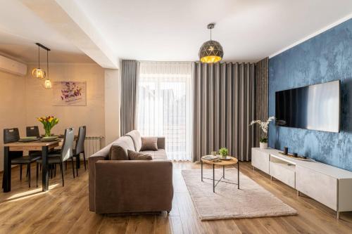 a living room with a couch and a tv at Villa Sol in Oświęcim