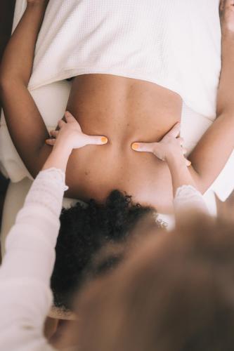 a man laying on a bed with his hands on his stomach at Hotel Enzian - Adults Only in Obertauern