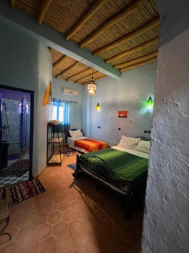 a bedroom with a bed in a room at Merzouga Camp and Hostel in Merzouga