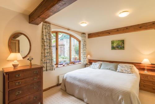 a bedroom with a bed and a dresser and a mirror at Valerian in York