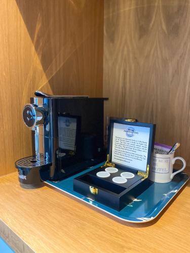 a coffee machine sitting on a counter with a coffee mug at The Swan Hotel and Spa in Newby Bridge