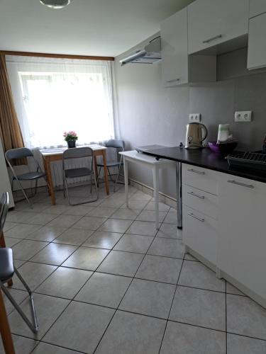 a kitchen with white cabinets and a counter top at U OLIWII in Krościenko