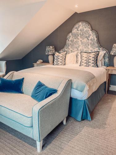 a large bedroom with a large bed and a couch at The Swan Hotel and Spa in Newby Bridge