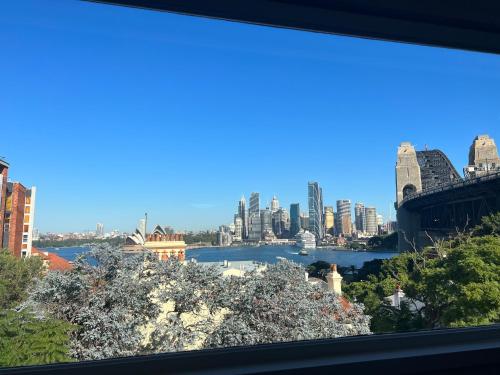 a view of the sydney city skyline from a window at Panorama Firework View - Classic 4-Level Terrace Style Living in Kirribilli !!! in Sydney