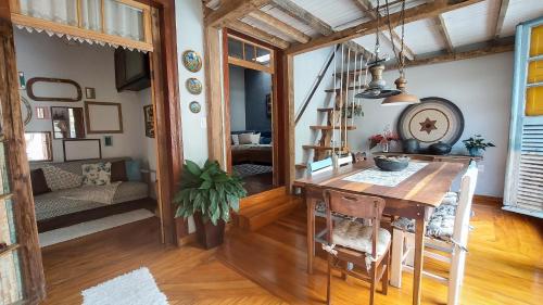 a room with a wooden table and a dining room at Suítes em casa centenária no centro de Socorro in Socorro