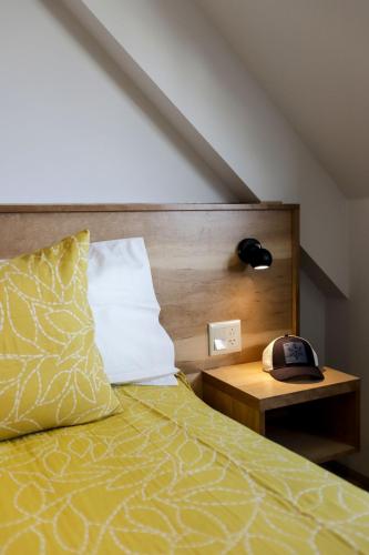 a bedroom with a bed and a phone on a table at Gente del Sur - Cinco Hermanos in Ushuaia