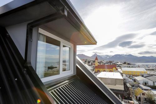 a balcony with a view of a city at Gente del Sur - Cinco Hermanos in Ushuaia