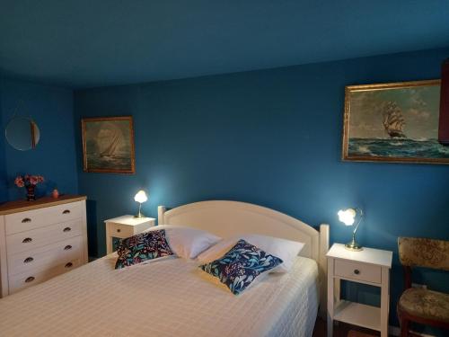 a bedroom with blue walls and a bed with two lamps at Villa Almond near Omis, private pool in Tugare
