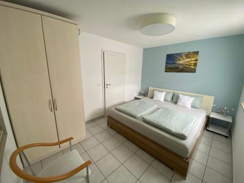 a bedroom with a bed and a chair in it at Downtown in Füssen