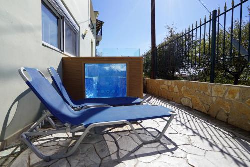 a pair of chairs and a table on a patio at SEMIRAMIS SUITES with pool in Kalamata