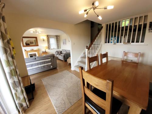 a dining room and living room with a table and chairs at Looe, Cornwall, Langunnett Cottage in Looe