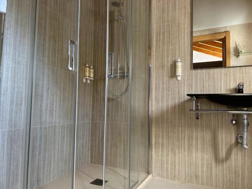 a bathroom with a shower and a sink at Quinta da Boavista in Vila Nova de Milfontes