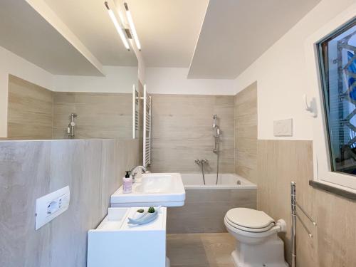 a bathroom with a sink and a toilet and a tub at Villetta La Rocca in Pietrasanta