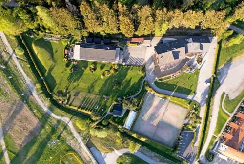 an aerial view of a house with a tennis court at Hotel SLUNEČNÁ LOUKA in Lipno nad Vltavou