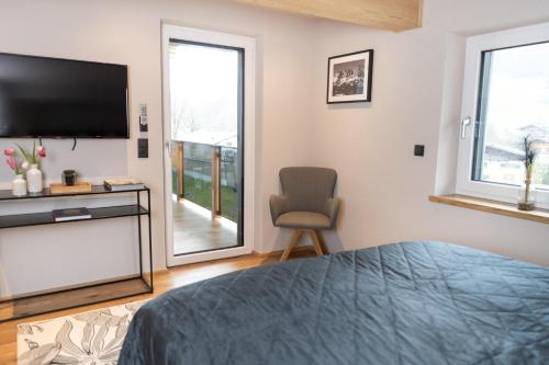 a bedroom with a bed and a tv and a chair at Going Living in Going