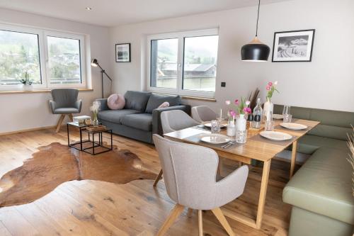 a living room with a table and a couch at Going Living in Going