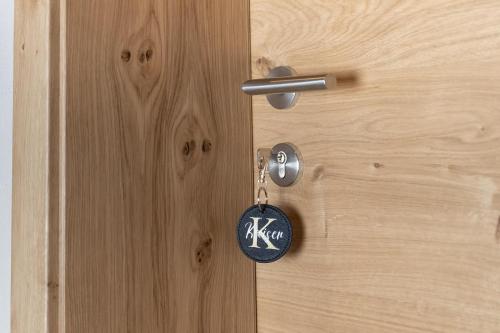 a wooden door with a key chain on it at Going Living in Going