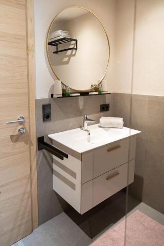 a bathroom with a sink and a mirror at Going Living in Going
