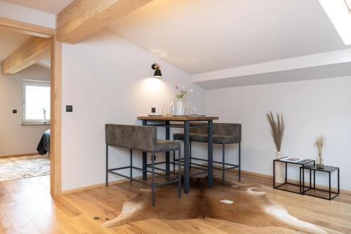 a dining room with a table and two stools at Going Living in Going