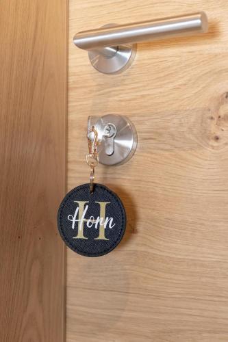 a key chain attached to a door with the word honour at Going Living in Going