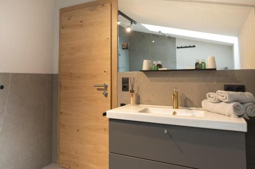 a bathroom with a sink and a mirror at Going Living in Going