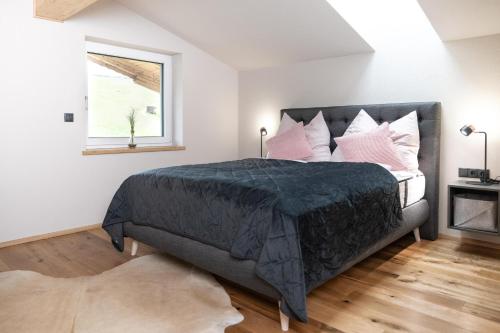 a bedroom with a large bed with pink pillows at Going Living in Going