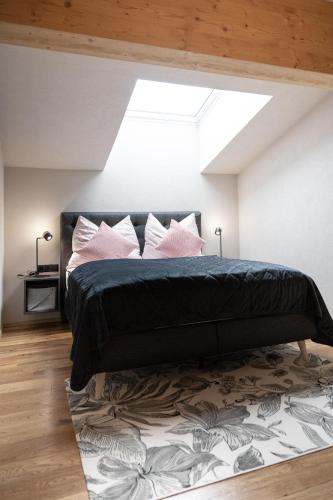 a bedroom with a bed and a skylight at Going Living in Going