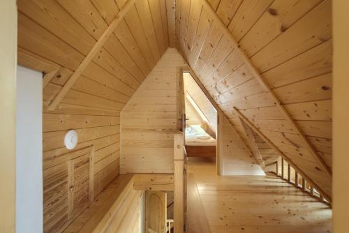 an attic room of a wooden cabin with a staircase at Osada Kościelisko - Tatry na Wyciągnięcie Ręki in Kościelisko