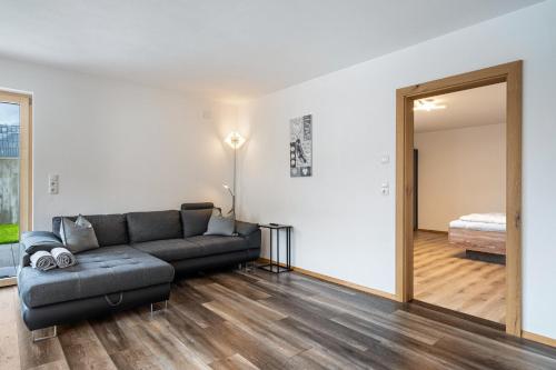 a living room with a couch and a bedroom at Steinwender in Kaltenbach