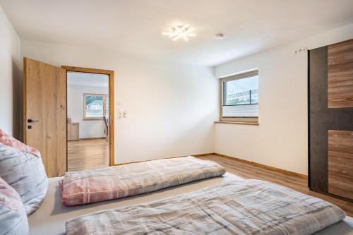 a bedroom with a bed and a large mirror at Steinwender in Kaltenbach