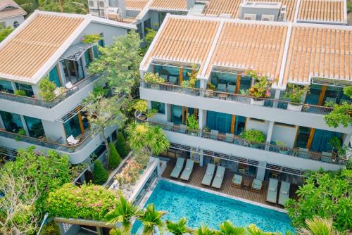 an aerial view of an apartment building with a swimming pool at CHiEM HoiAn - The Beachside Boutique Hotel & Villa in Hoi An